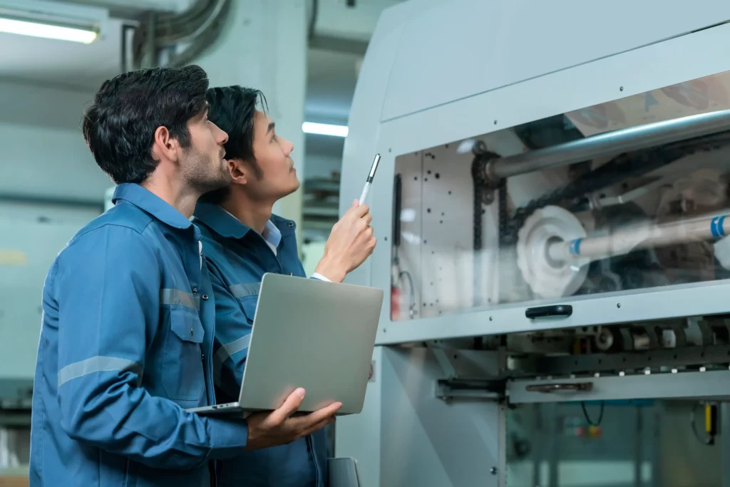 Two engineers inspecting a machine