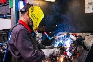 Man wearing protective clothing and Soldering