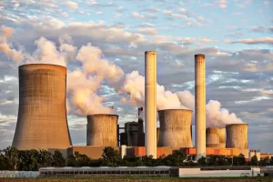 Smoke rising from a power plant's stacks, a result of energy generation