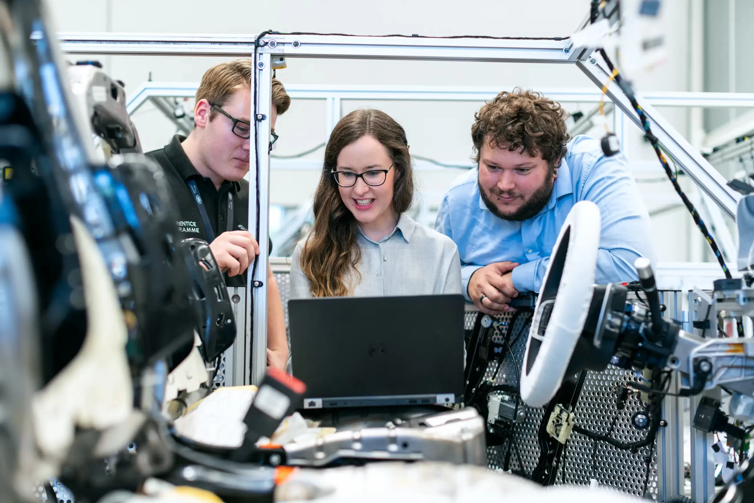 woman and men collaborate on a project using a laptop